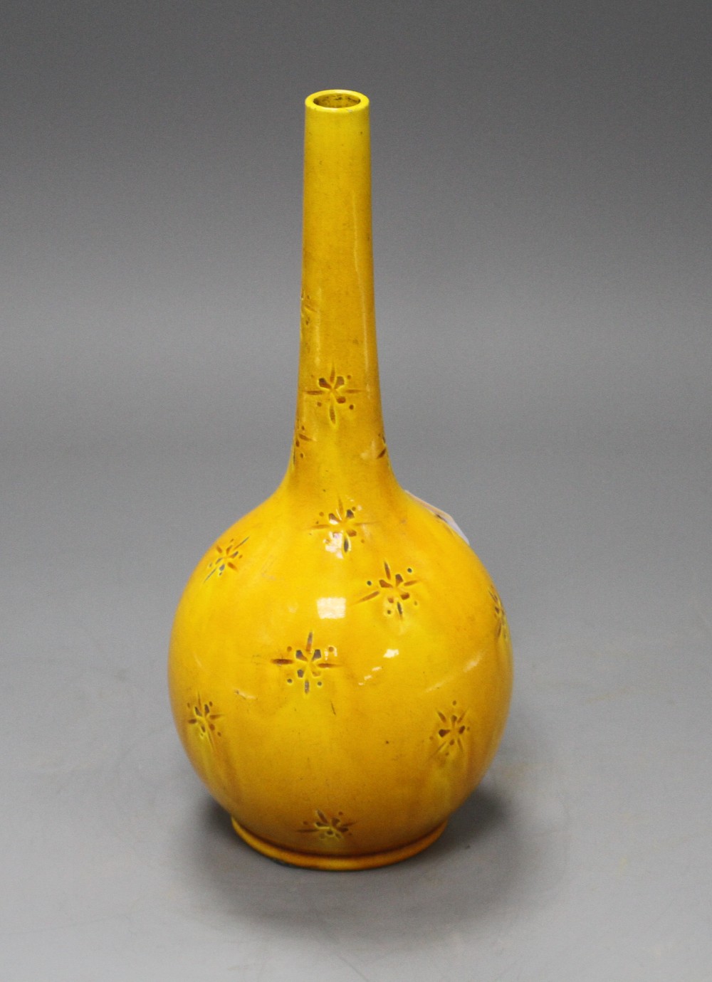A Burmantofts yellow glazed vase, with impressed stylised floral decoration, monogrammed and numbered 358, height 23cm